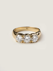 Round cut lab grown diamond three stone engagement ring, 1.50 to 3.50 carats, set in prong design on polished gold band