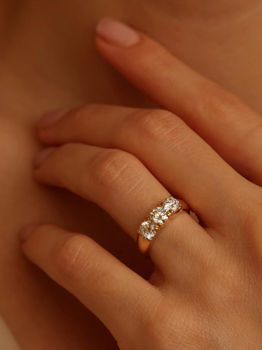 Round cut lab grown diamond three stone engagement ring, 1.50 to 3.50 carats, set in prong design on polished gold band