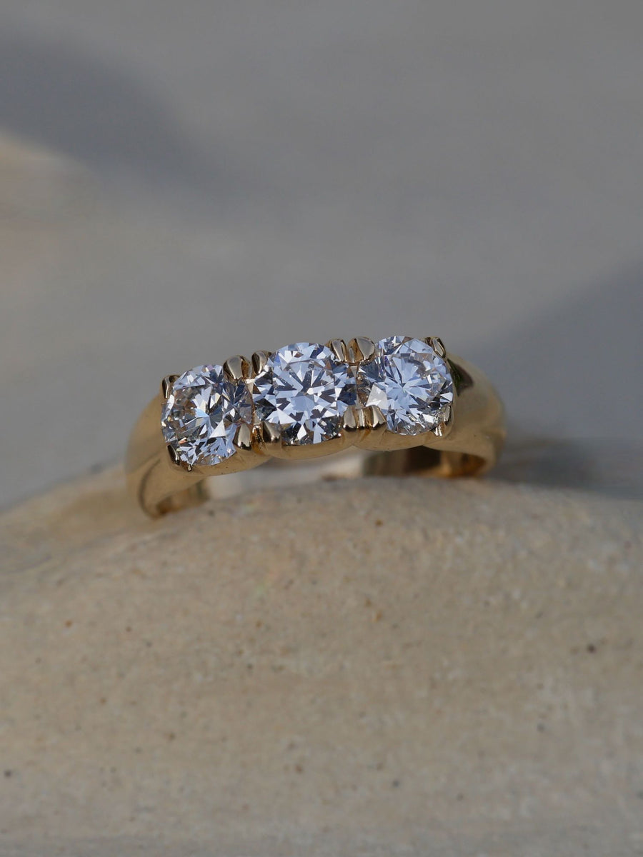 Round cut lab grown diamond three stone engagement ring, 1.50 to 3.50 carats, set in prong design on polished gold band