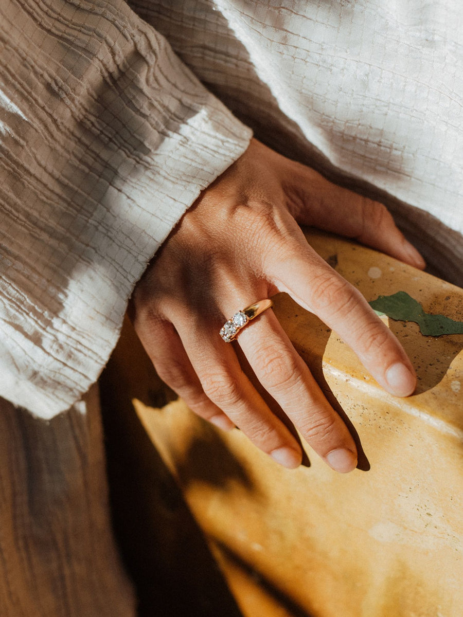 Round cut lab grown diamond three stone engagement ring, 1.50 to 3.50 carats, set in prong design on polished gold band