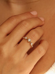 0.11 carat round cut lab grown diamond dainty engagement ring in a slim prong setting on polished gold band