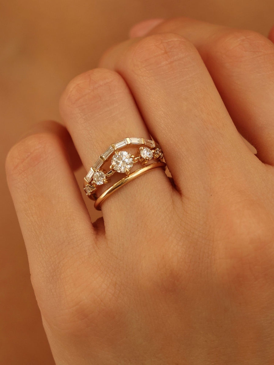 0.11 carat round cut lab grown diamond dainty engagement ring in a slim prong setting on polished gold band