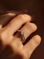 0.11 carat round cut lab grown diamond dainty engagement ring in a slim prong setting on polished gold band