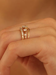 0.11 carat round cut lab grown diamond dainty engagement ring in a slim prong setting on polished gold band