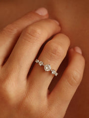 0.11 carat round cut lab grown diamond dainty engagement ring in a slim prong setting on polished gold band