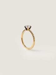 Round cut E/VS1 lab grown diamond pavé engagement ring, 0.50 to 2.50 carats, with side stones set in polished gold band

