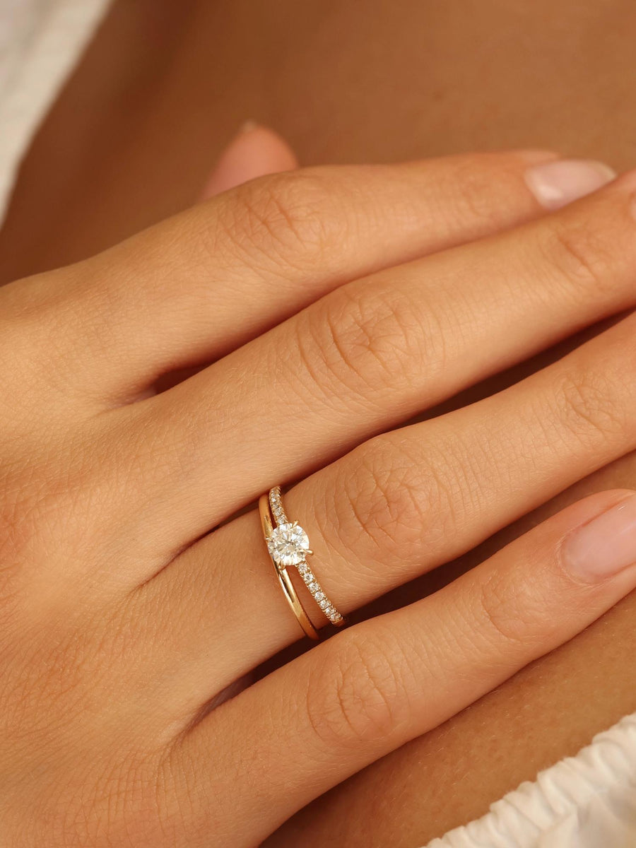 Round cut E/VS1 lab grown diamond pavé engagement ring, 0.50 to 2.50 carats, with side stones set in polished gold band
