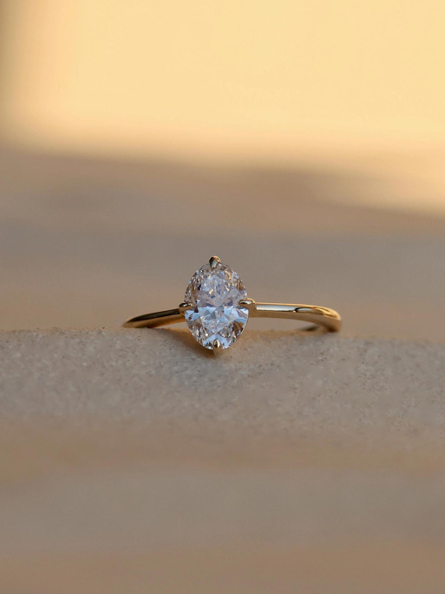 Oval cut lab grown diamond solitaire engagement ring, 1.0 to 3.0 carats, set in classic prong setting on polished gold band