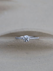 Round cut E/VS1 lab grown diamond pavé engagement ring, 0.50 to 2.50 carats, with side stones set in polished gold band
