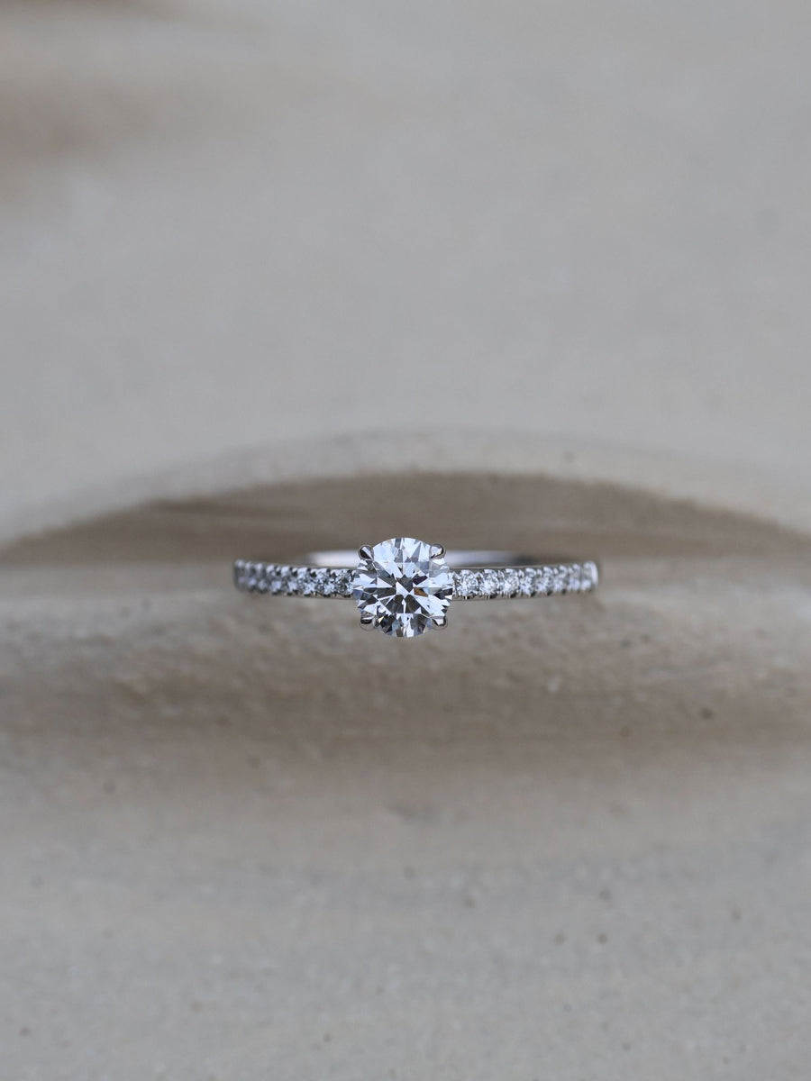 Round cut E/VS1 lab grown diamond pavé engagement ring, 0.50 to 2.50 carats, with side stones set in polished gold band
