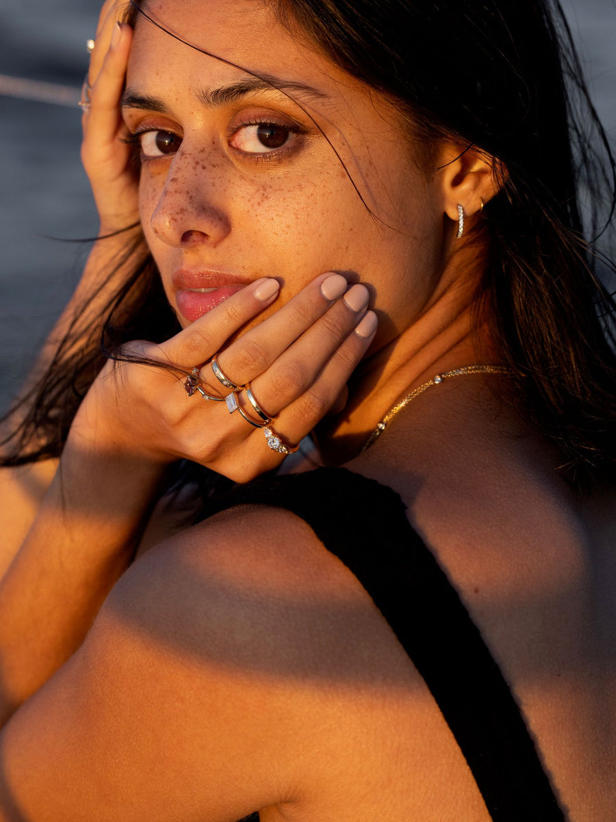 East-west emerald cut lab grown diamond solitaire engagement ring, 1.0 to 3.0 carats, set in prong design on polished gold band
