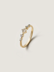 0.11 carat round cut lab grown diamond dainty engagement ring in E/VS1 clarity, set in a slim gold band with prong setting

