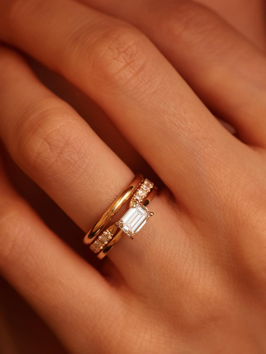 East-west emerald cut lab grown diamond solitaire engagement ring, 1.0 to 3.0 carats, set in prong design on polished gold band
