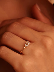 East-west emerald cut lab grown diamond solitaire engagement ring, 1.0 to 3.0 carats, set in prong design on polished gold band
