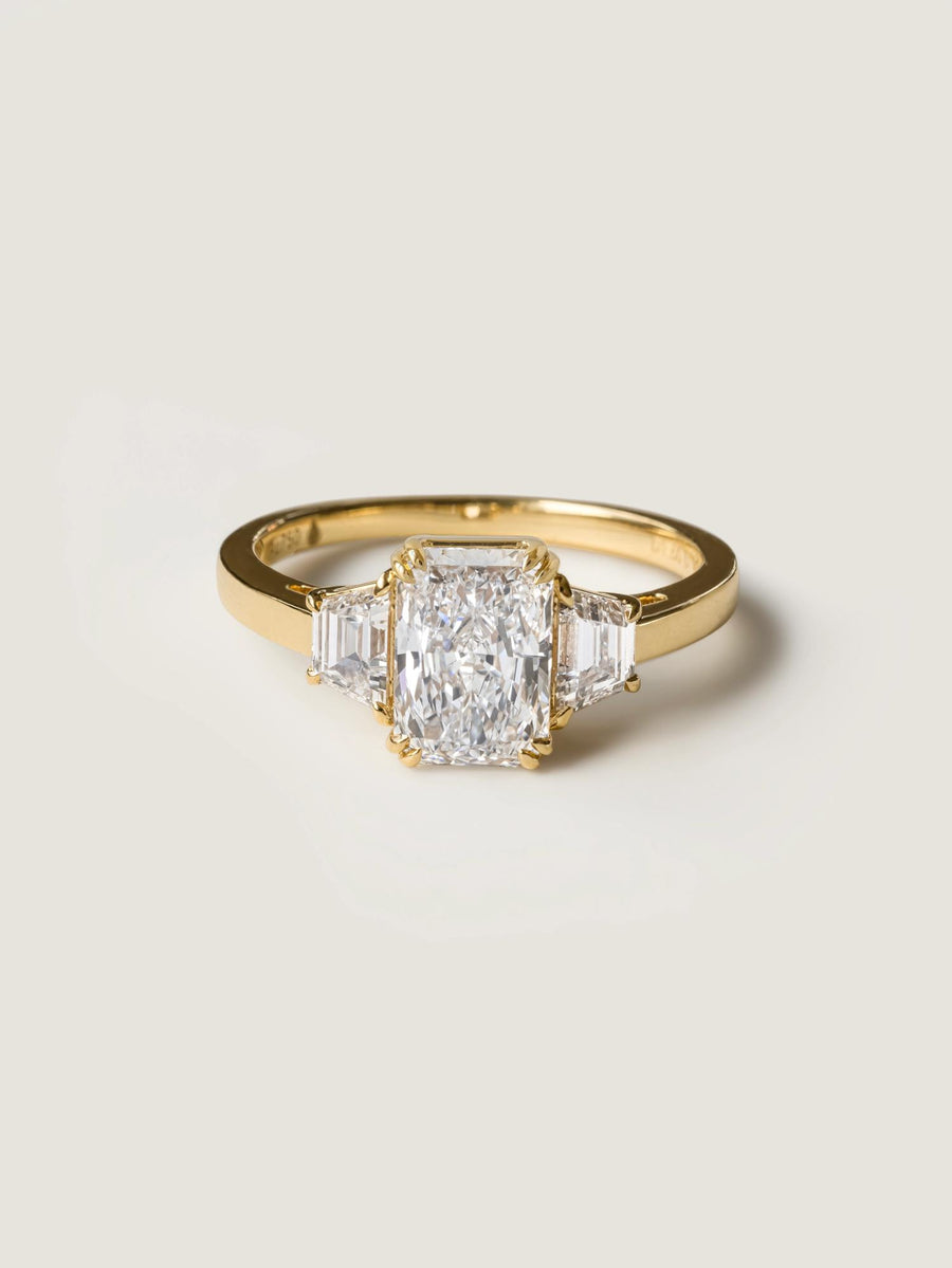 Radiant cut lab grown diamond three stone engagement ring, 1.0 to 3.0 carats, set in elegant prong setting on gold band