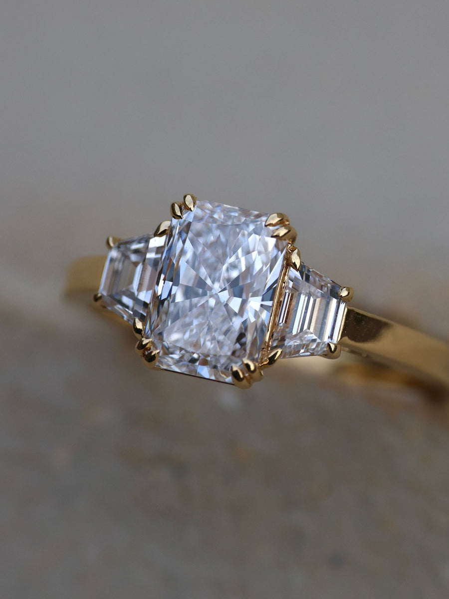 Radiant cut lab grown diamond three stone engagement ring, 1.0 to 3.0 carats, set in elegant prong setting on gold band