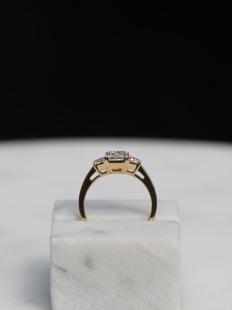 Radiant cut lab grown diamond three stone engagement ring, 1.0 to 3.0 carats, set in elegant prong setting on gold band
