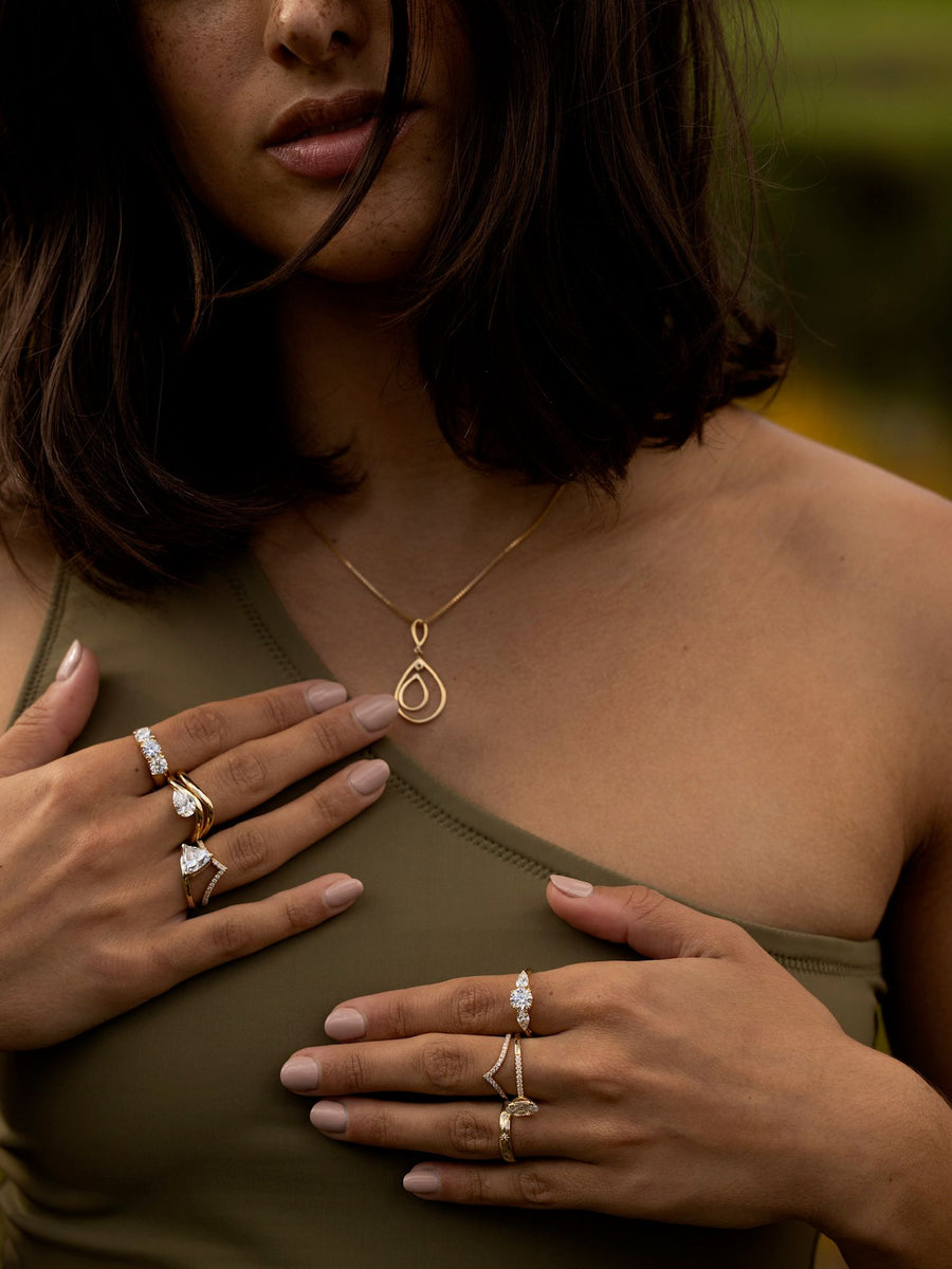 0.50 carat round cut lab grown diamond three stone engagement ring with prong setting on polished gold band