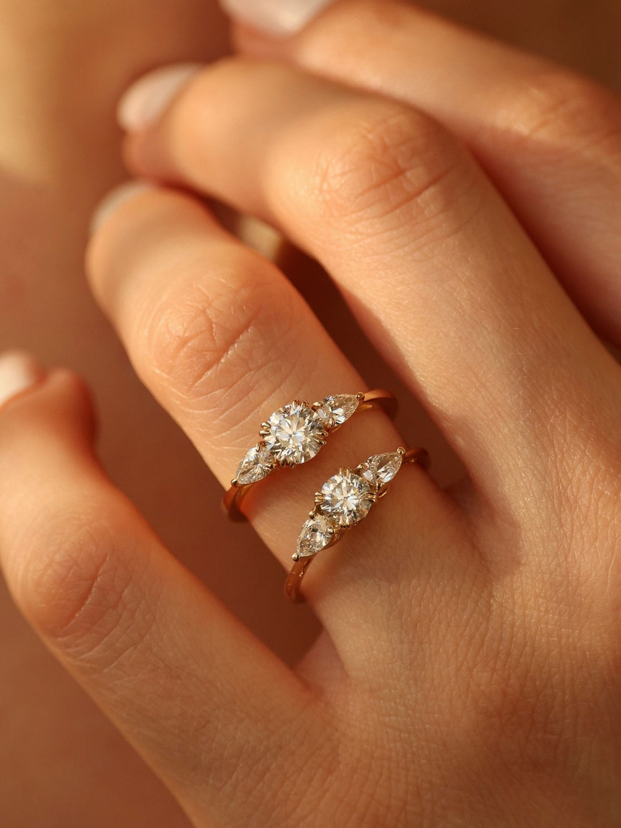 0.50 carat round cut lab grown diamond three stone engagement ring with prong setting on polished gold band