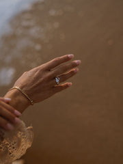 0.50 carat round cut lab grown diamond three stone engagement ring with prong setting on polished gold band