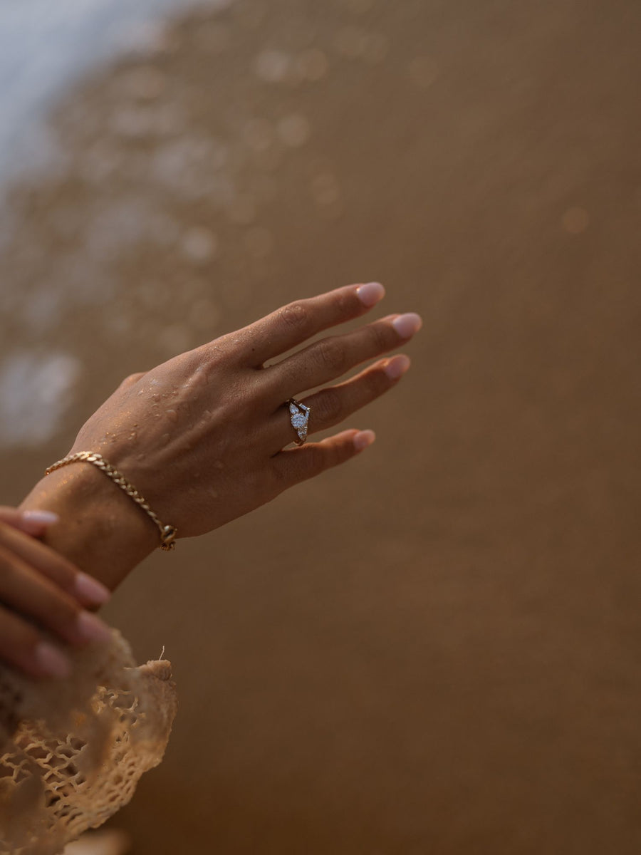 0.50 carat round cut lab grown diamond three stone engagement ring with prong setting on polished gold band