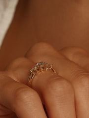 0.50 carat round cut lab grown diamond three stone engagement ring with prong setting on polished gold band