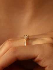 0.50 carat round cut lab grown diamond three stone engagement ring with prong setting on polished gold band