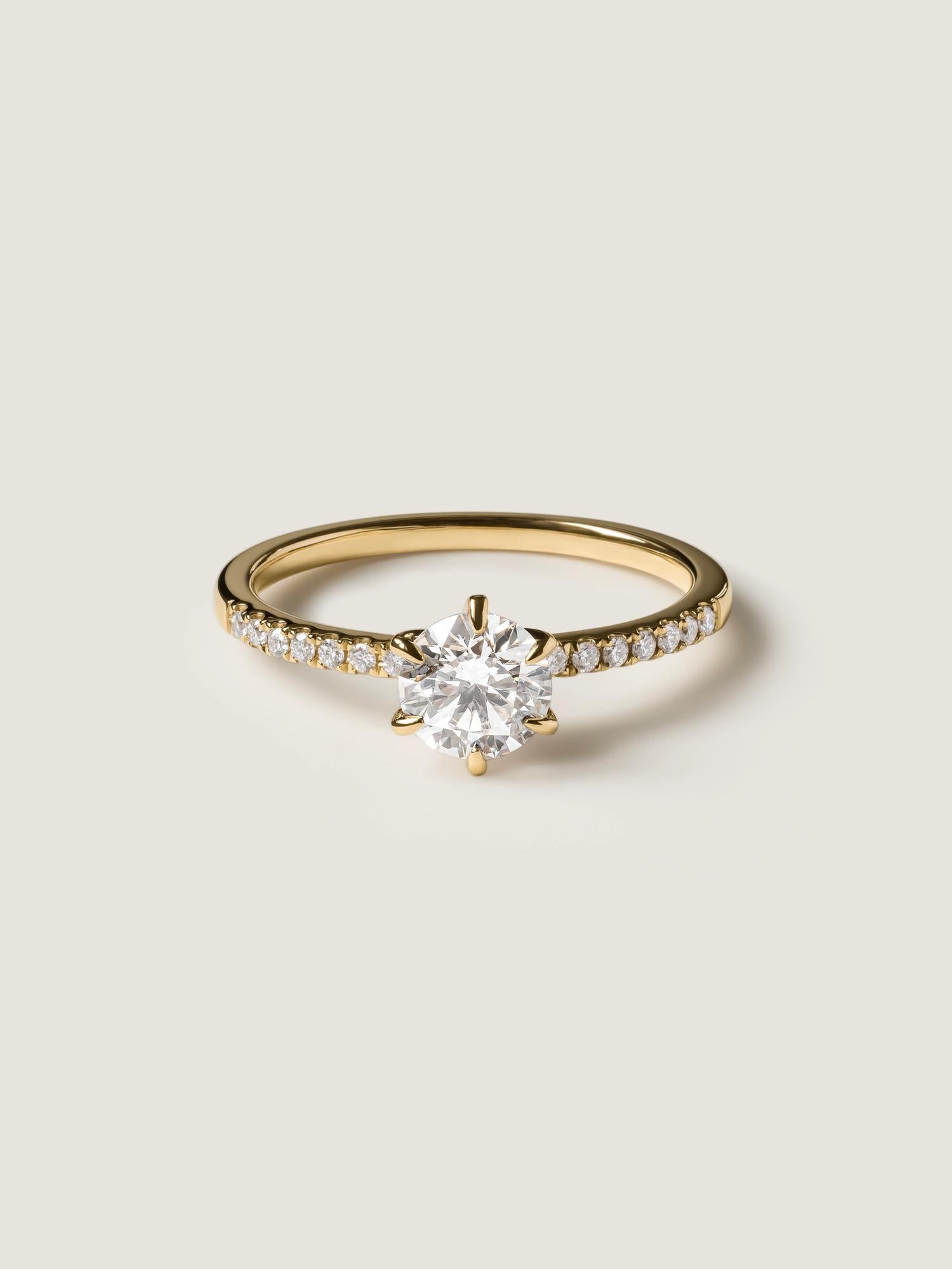 Round cut lab grown diamond pavé engagement ring, 0.75 to 2.75 carats, with side stones in elegant prong setting on polished gold band