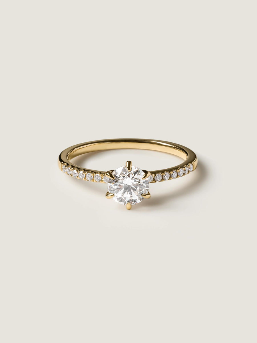 Round cut lab grown diamond pavé engagement ring, 0.75 to 2.75 carats, with side stones in elegant prong setting on polished gold band