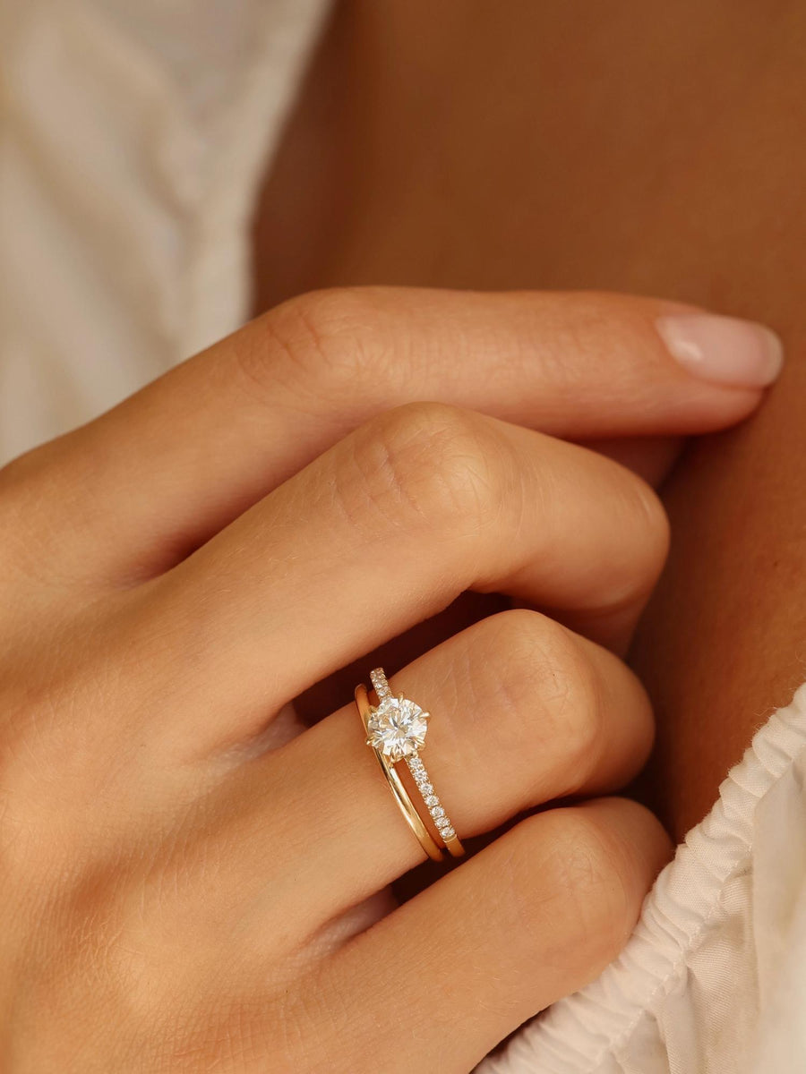 Round cut lab grown diamond pavé engagement ring, 0.75 to 2.75 carats, with side stones in elegant prong setting on polished gold band