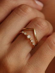 0.11 carat round cut lab grown diamond dainty engagement ring in E/VS1 clarity, set in a slim gold band with prong setting