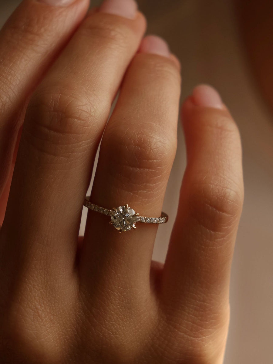 Round cut lab grown diamond pavé engagement ring, 0.75 to 2.75 carats, with side stones in elegant prong setting on polished gold band