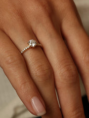 Round cut lab grown diamond pavé engagement ring, 0.75 to 2.75 carats, with side stones in elegant prong setting on polished gold band