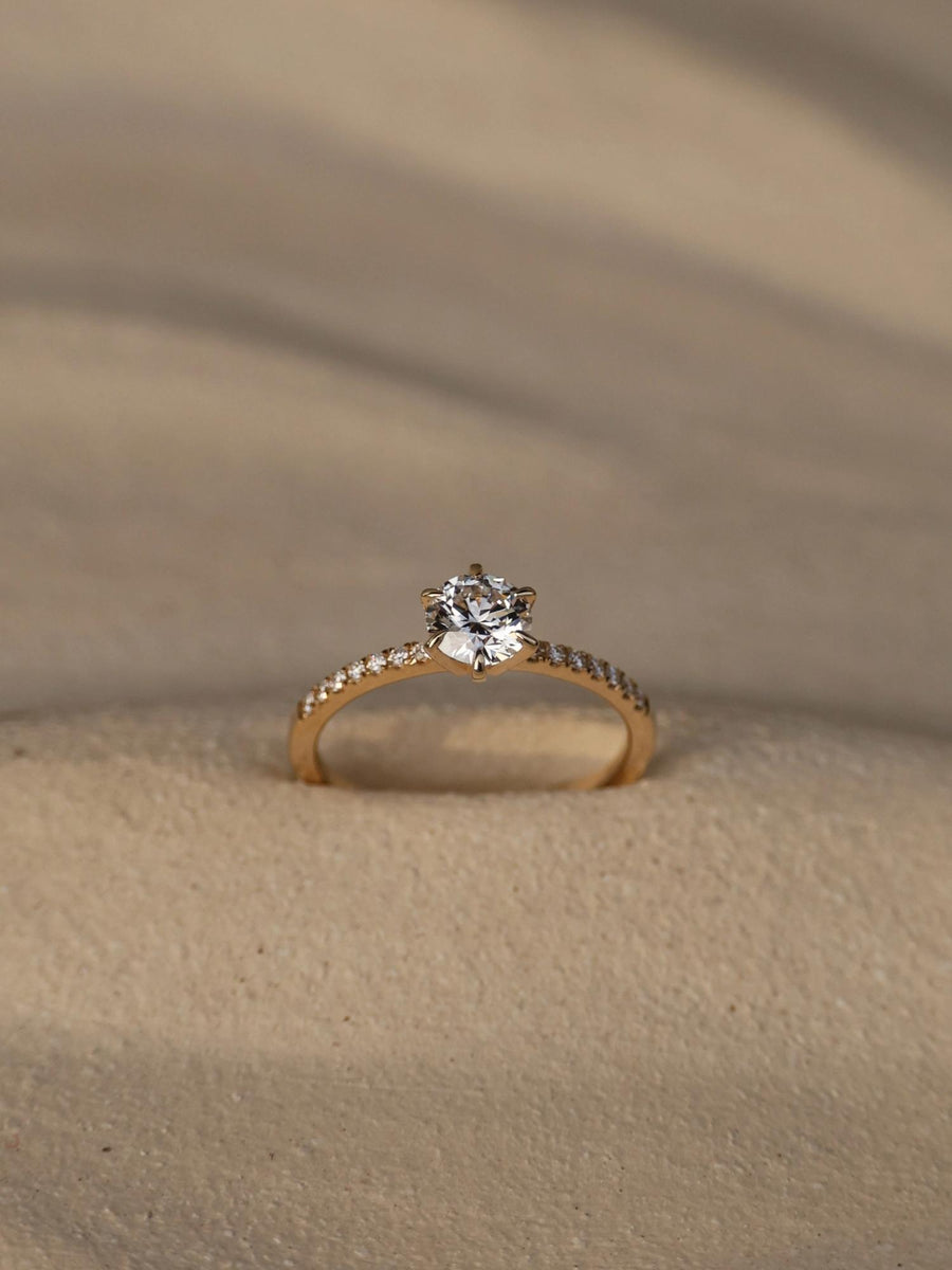 Round cut lab grown diamond pavé engagement ring, 0.75 to 2.75 carats, with side stones in elegant prong setting on polished gold band