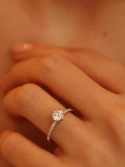 Round cut lab grown diamond pavé engagement ring, 0.75 to 2.75 carats, with side stones in elegant prong setting on polished gold band