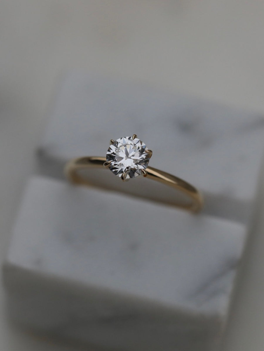 Round cut lab grown diamond solitaire engagement ring, 0.75 to 2.75 carats, set in a classic prong design on polished gold band