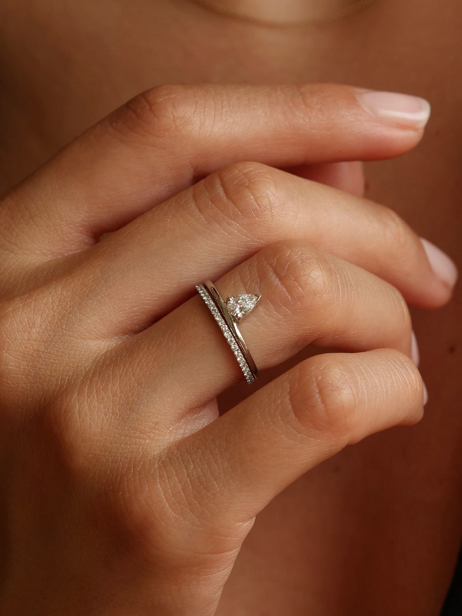 0.30 carat pear cut lab grown diamond solitaire engagement ring in prong setting on polished gold band