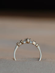 0.11 carat round cut lab grown diamond dainty engagement ring in E/VS1 clarity, set in a slim gold band with prong setting


