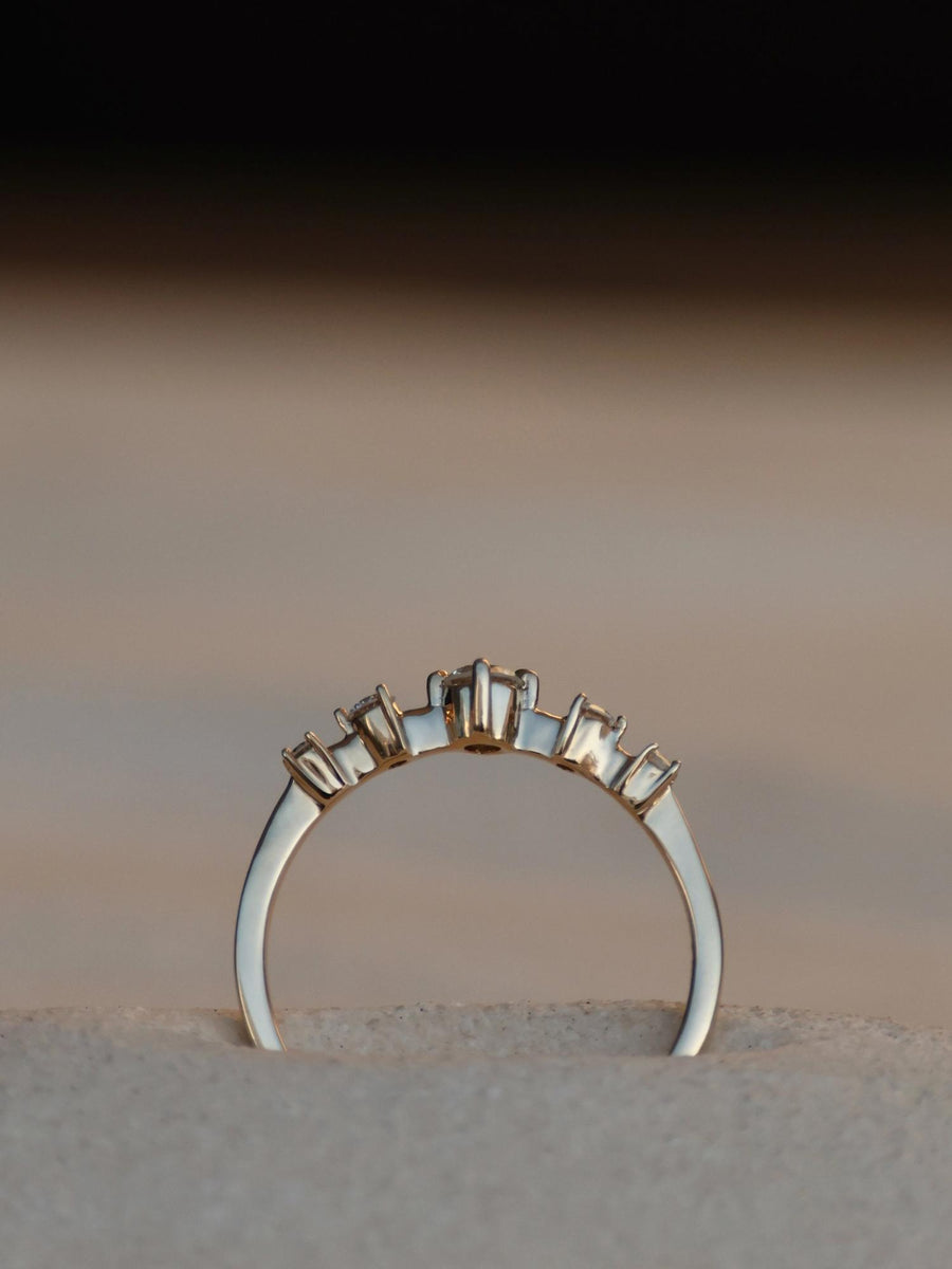 0.11 carat round cut lab grown diamond dainty engagement ring in E/VS1 clarity, set in a slim gold band with prong setting


