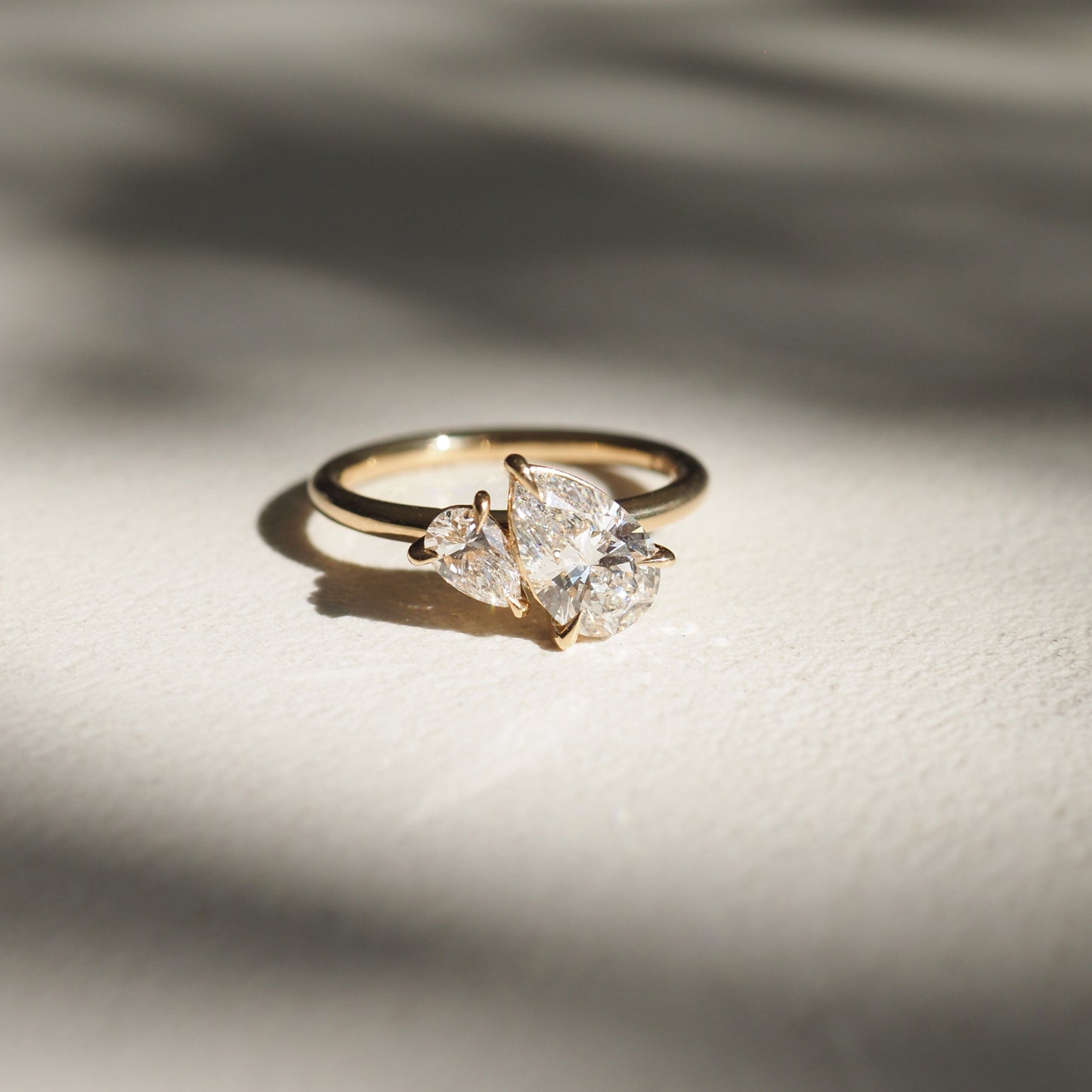 1.5 carat pear cut lab grown diamond two stone engagement ring with G/VS clarity, set in polished gold band with prong setting