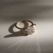 Oval and radiant cut lab grown diamond two stone engagement ring in elegant prong setting on polished gold band