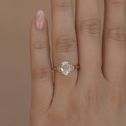 Oval cut lab grown diamond engagement ring with multiple accent stones set in polished band for added brilliance