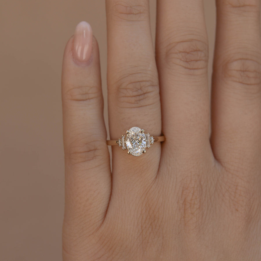 Oval cut lab grown diamond engagement ring with multiple accent stones set in polished band for added brilliance