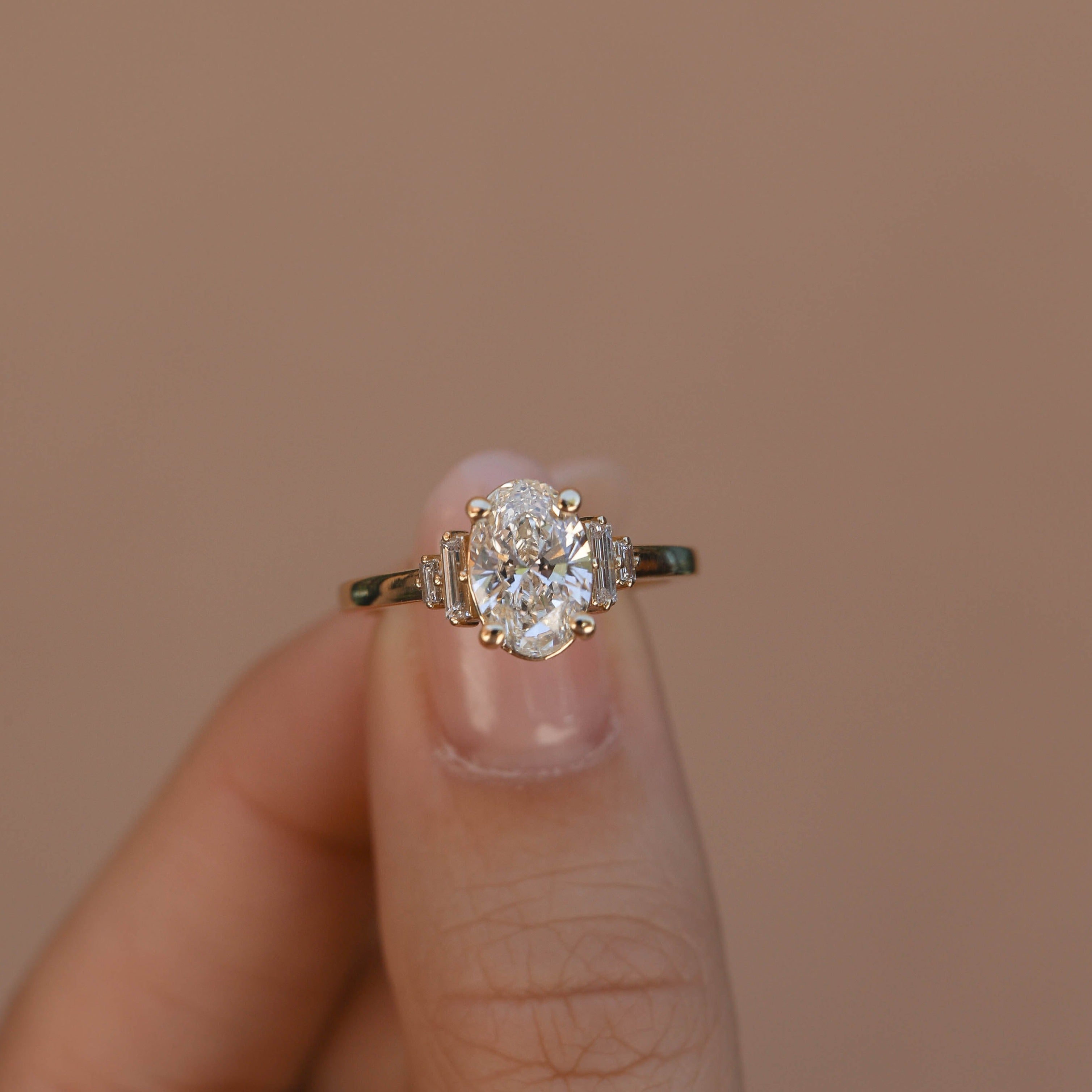 Oval cut lab grown diamond engagement ring with multiple accent stones set in polished band for added brilliance