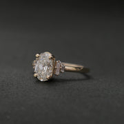 Oval cut lab grown diamond engagement ring with multiple accent stones set in polished band for added brilliance