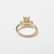 1.29 carat emerald cut lab grown diamond three stone engagement ring in G/VS1 clarity with baguette side stones and polished metal band