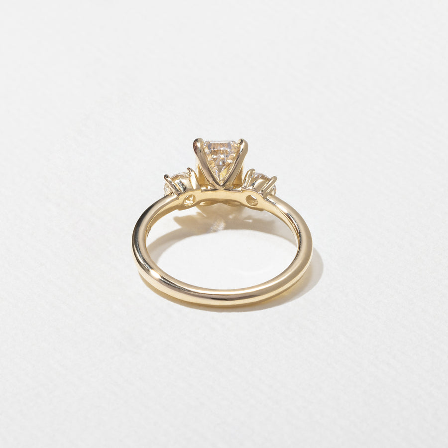 1.29 carat emerald cut lab grown diamond three stone engagement ring in G/VS1 clarity with baguette side stones and polished metal band