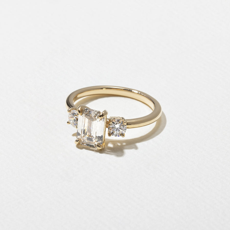 1.29 carat emerald cut lab grown diamond three stone engagement ring in G/VS1 clarity with baguette side stones and polished metal band