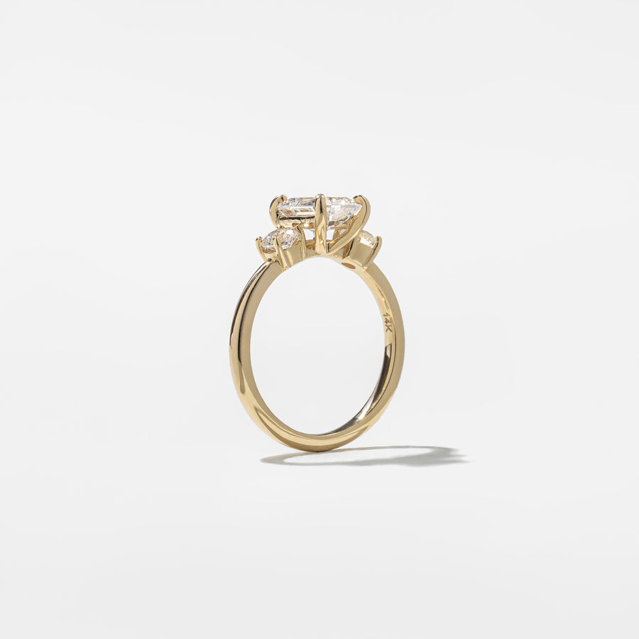 1.29 carat emerald cut lab grown diamond three stone engagement ring in G/VS1 clarity with baguette side stones and polished metal band