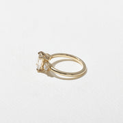 1.29 carat emerald cut lab grown diamond three stone engagement ring in G/VS1 clarity with baguette side stones and polished metal band